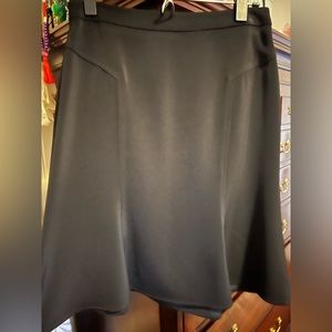 Beautiful black polyester mid length skirt. It comes a little above my shins.